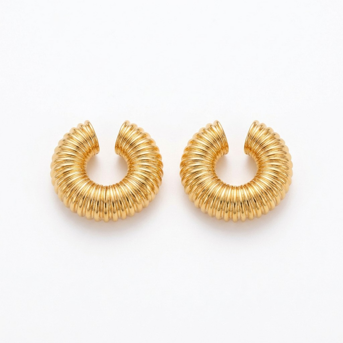 Tania Claire Australia gold-tone ribbed ear cuffs with a chunky circular design for a sculptural, high-shine look.