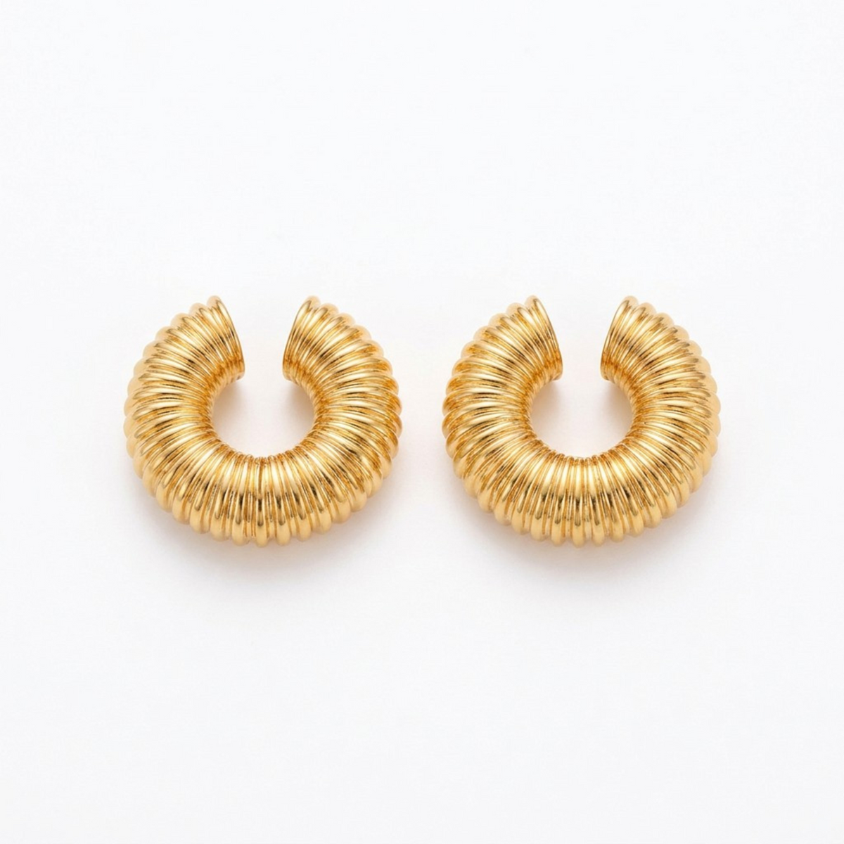 Tania Claire Australia gold-tone Nervure ear cuffs featuring a chunky, sculptural ribbed texture design.