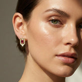 Tania Claire Australia gold shield earrings with ruby and diamonds on a model.