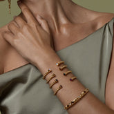 Tania Claire Australia gold vermeil Inner Flame bangle with garnet and crystal accents, inspired by feminine strength.