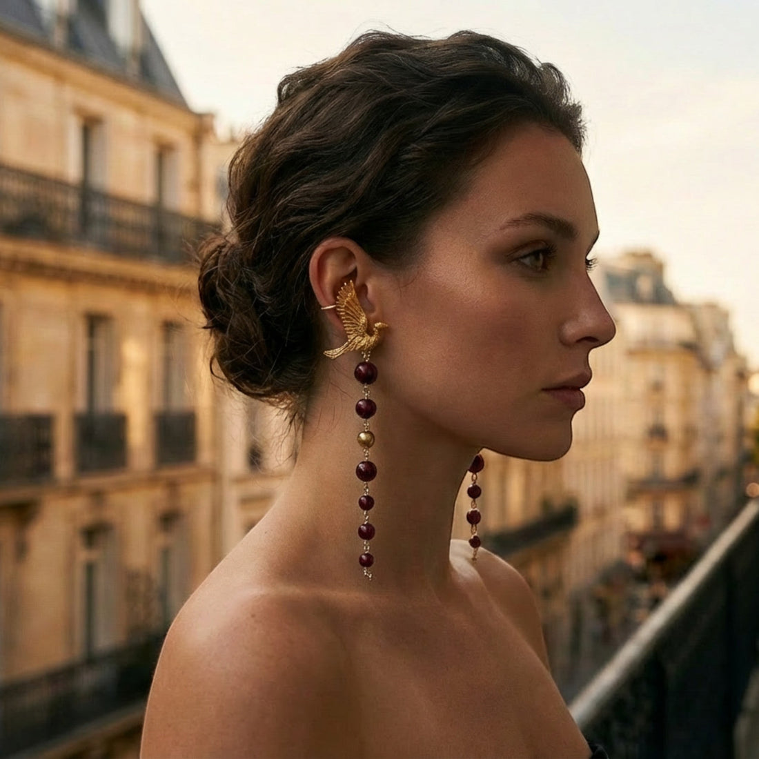 Tania Claire Australia gold pilgrim wing earrings with dangling deep red beads and gold accents.