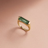 Tania Claire Australia Sylvia ring with a rectangular green tourmaline stone set in a yellow gold frame.