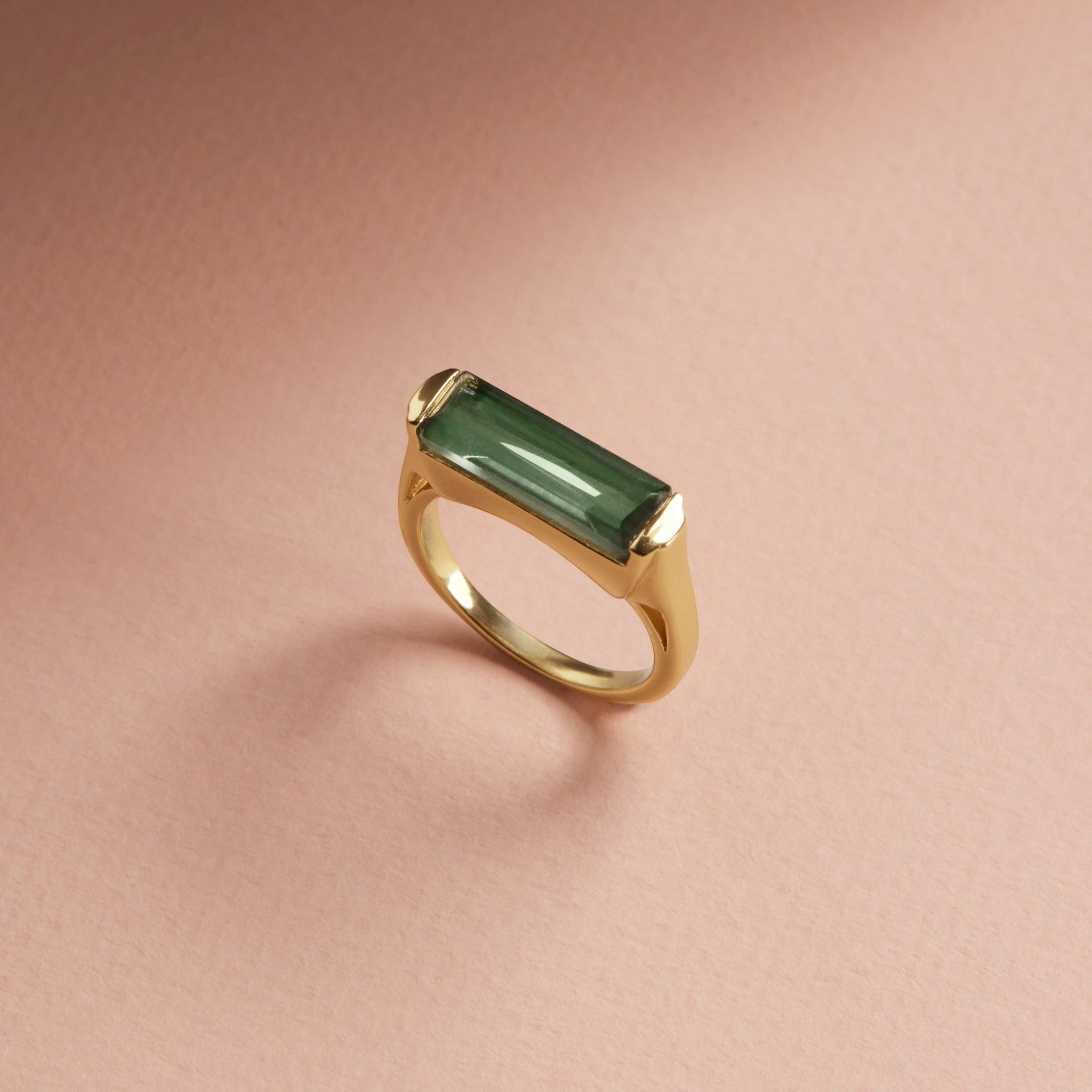 Tania Claire Australia Sylvia ring with a rectangular green tourmaline stone set in a yellow gold frame.