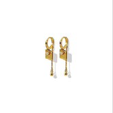 Tania Claire Australia gold-plated hoop earrings with square charm, cubic zirconia, and dangling chain with bead.