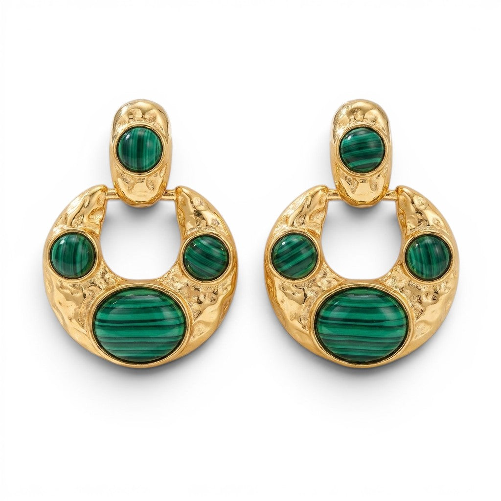 Tania Claire Australia crescent hoop earrings in hammered gold with green malachite cabochons on a white background.