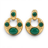 Tania Claire Australia crescent hoop earrings in hammered gold with green malachite cabochons on a white background.