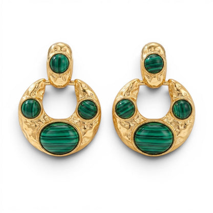 Tania Claire Australia crescent hoop earrings in hammered gold with green malachite cabochons on a white background.