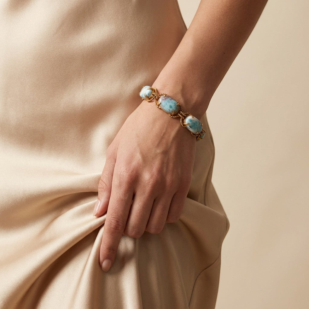 Tania Claire Australia Holly gemstone twist bracelet with blue cabochon stones and gold plating on a model&