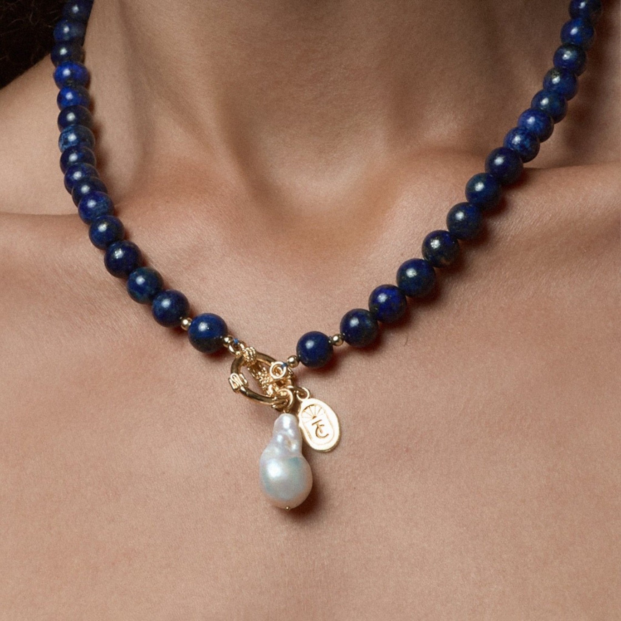 Tania Claire Australia Midnight Offering necklace with lapis lazuli beads, baroque pearl drop, and gold-plated sterling silver clasp.
