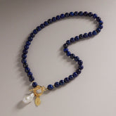 Tania Claire Australia Midnight Offering necklace with lapis lazuli beads, baroque pearl, and gold plated toggle clasp.