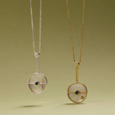 Tania Claire Australia Lunar Orbit Necklace: 14K gold, mother-of-pearl disc, sapphire, diamond accent. Elegant celestial design.