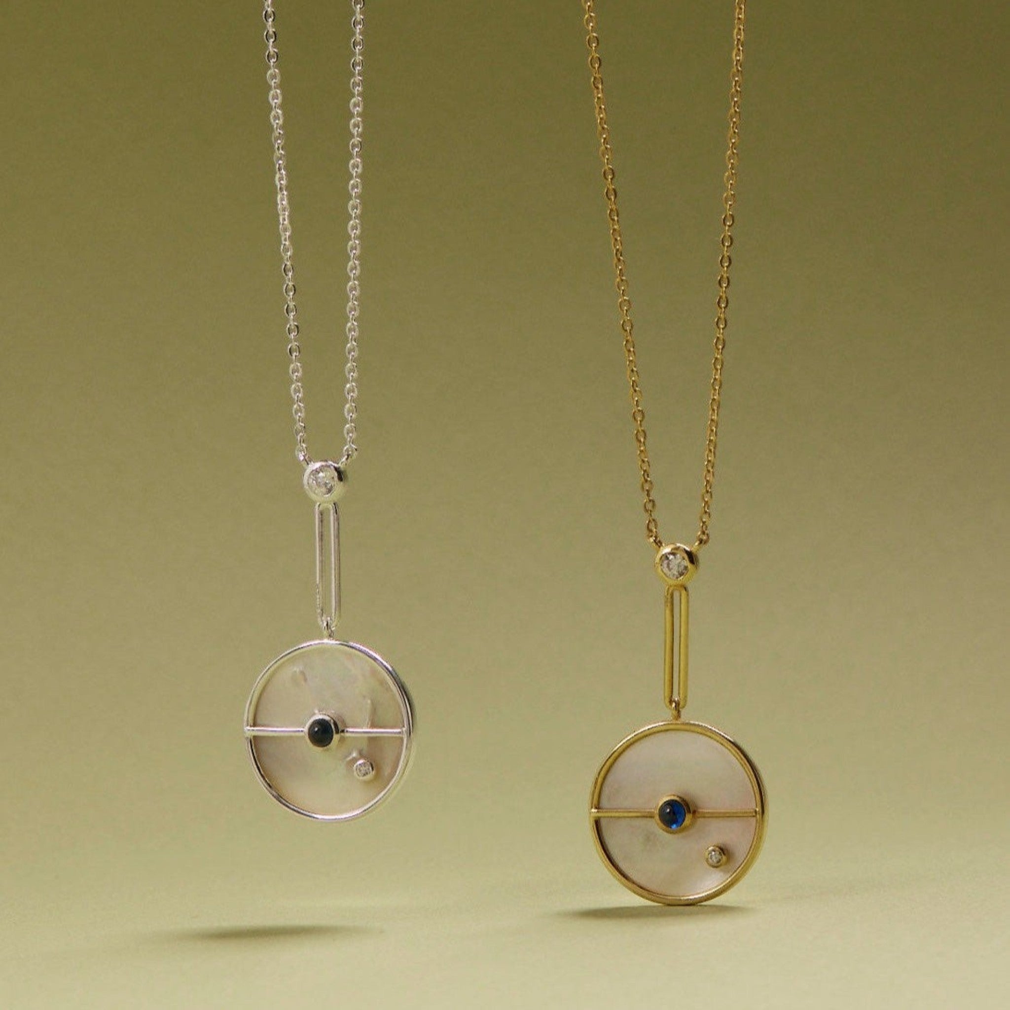 Tania Claire Australia Lunar Orbit Necklace: 14K gold, mother-of-pearl disc, sapphire, diamond accent. Elegant celestial design.