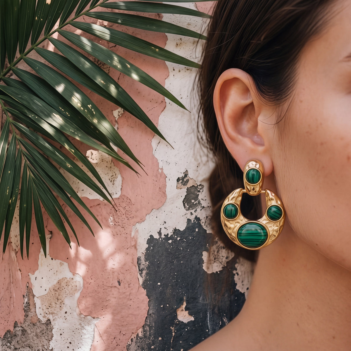 Tania Claire Australia hammered gold crescent hoop earrings with green malachite stones worn on a woman&