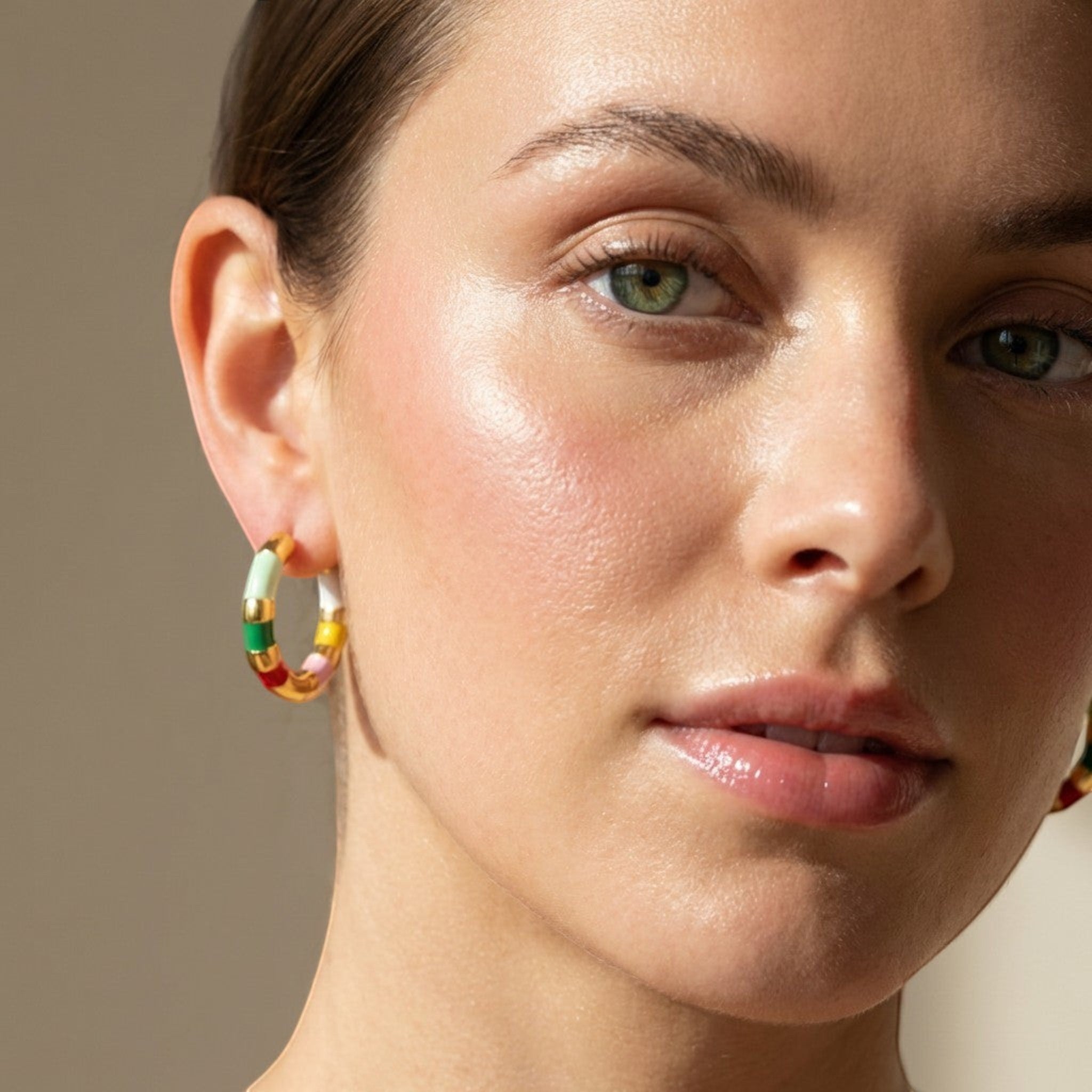 Tania Claire Australia Mini Confetti gold-plated hoop earrings with colorful enamel stripes in green, yellow, red, white, and pink.