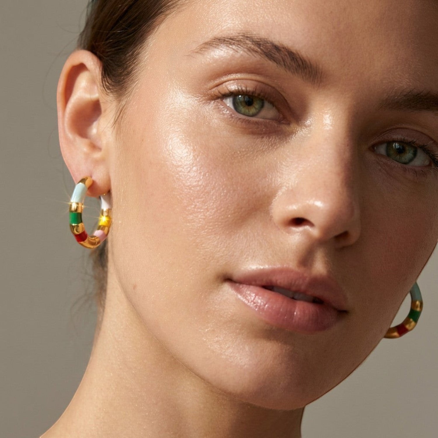 Tania Claire Australia Mini Confetti gold-plated hoop earrings with colorful enamel stripes in green, yellow, red, white, and pink.