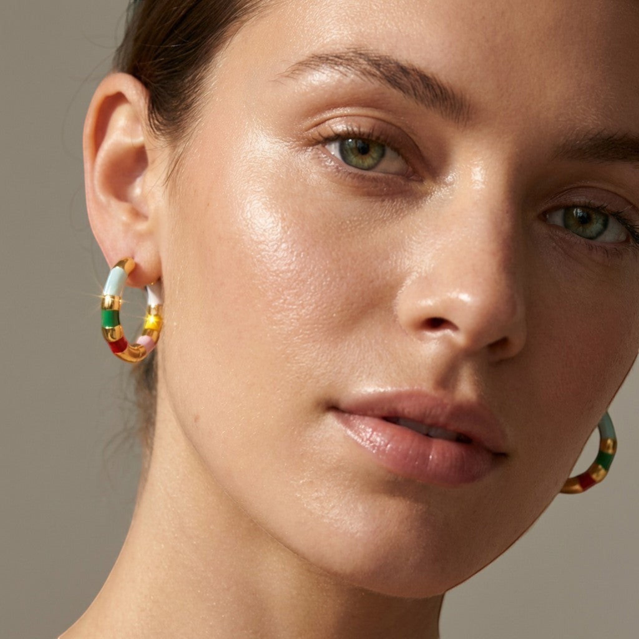 Tania Claire Australia Mini Confetti gold-plated hoop earrings with colorful enamel stripes in green, yellow, red, white, and pink.
