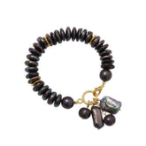 Tania Claire Australia Étoile Noir Bracelet: strand of iridescent midnight freshwater pearls with baroque pearl charms and gold clasp.