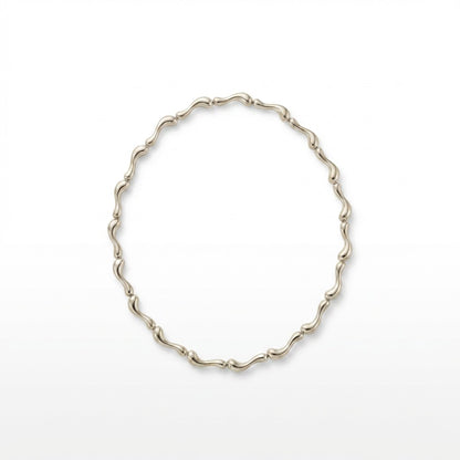 Tania Claire Australia Ocean Spine Necklace in sterling silver, featuring sculpted wave-like links for a fluid, coastal-inspired design.