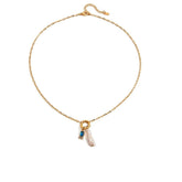 Tania Claire Australia gold plated stainless steel necklace featuring a lustrous pearl and a blue birthstone charm.