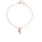 Tania Claire Australia gold plated stainless steel necklace featuring a lustrous pearl and a red birthstone charm.