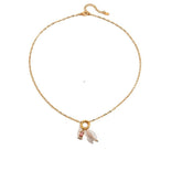 Tania Claire Australia gold-plated stainless steel necklace featuring a lustrous pearl and a pink birthstone charm.