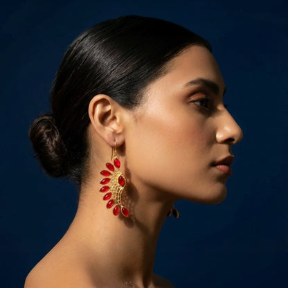 Tania Claire Australia gold-tone phoenix wing earrings with red marquise-cut garnets in an open lattice setting.