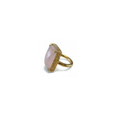 Tania Claire Australia gold-plated brass ring with a large, pale pink cabochon gemstone and textured band.
