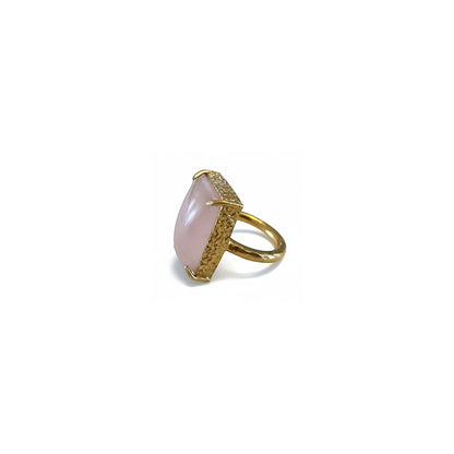 Tania Claire Australia gold-plated brass ring with a large, pale pink cabochon gemstone and textured band.