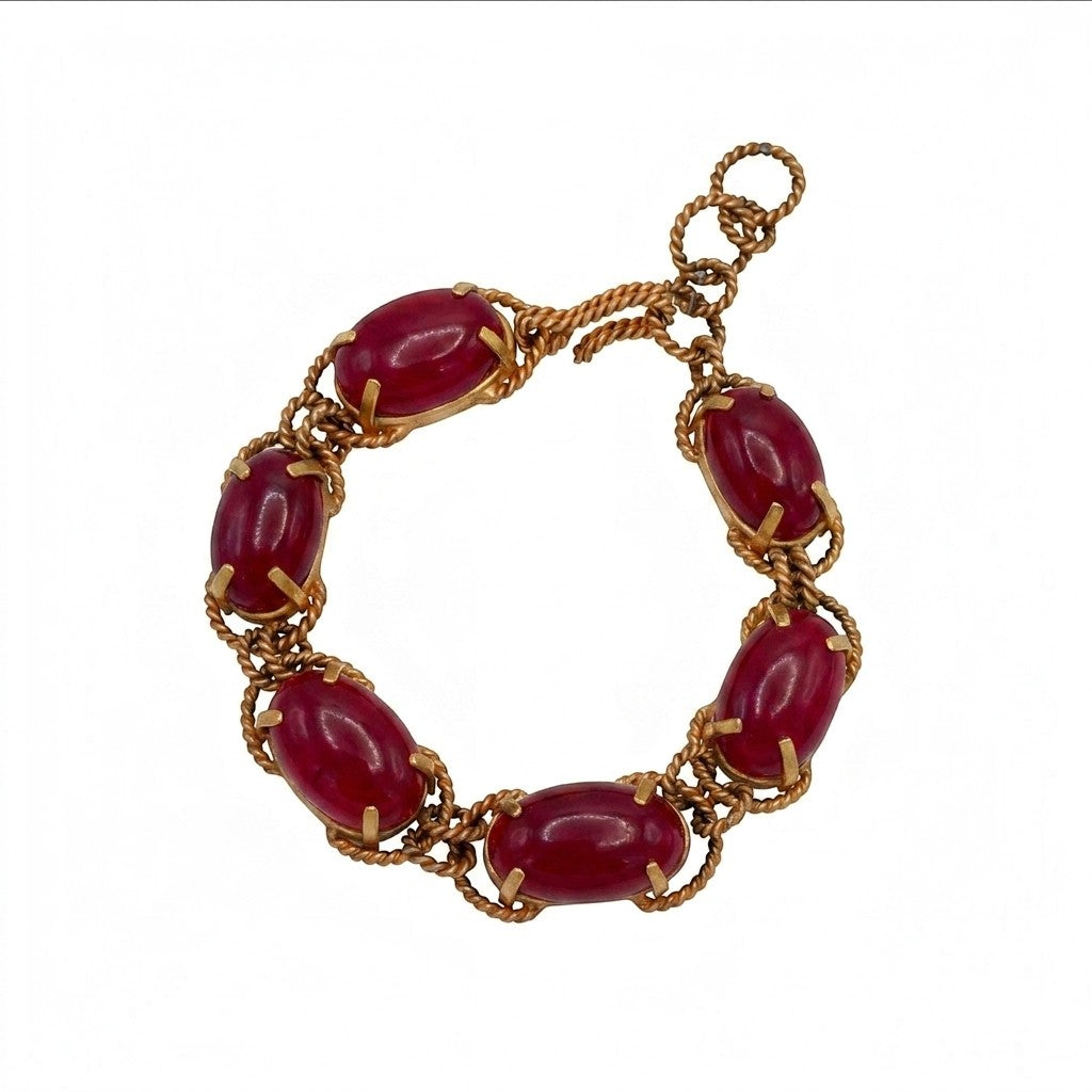 Tania Claire Australia gold-plated twist bracelet featuring deep red cabochon gemstones in a linked chain design.