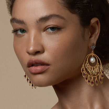Tania Claire Australia Sacred Bloom earrings featuring gold-plated sterling silver, pearl, garnet, and peridot stones.