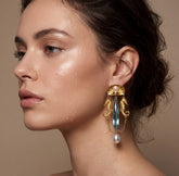 Tania Claire Australia antique revival seahorse earrings with blue teardrop crystals and pearls on a model