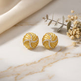 Tania Claire Australia Solaris Studs: 14K gold plated sterling silver earrings with swirling texture and pavé crystals.