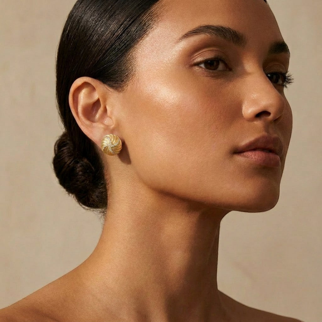 Tania Claire Australia Solaris Studs: 14K gold-plated sterling silver earrings with textured swirls and pavé crystals.
