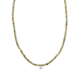 A gold-colored necklace with small clear crystals and a clear crystal pendant, measuring 40cm in length.