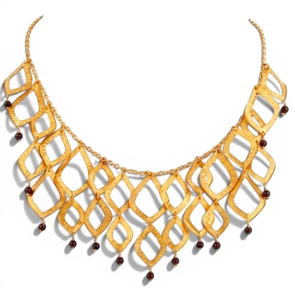 Tania Claire Australia Temple Flame necklace featuring architectural gold brass lattice with dangling garnet gemstones.
