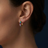 Tania Claire Australia gold-plated brass hoop earrings with colourful teal, violet, and pink enamel.