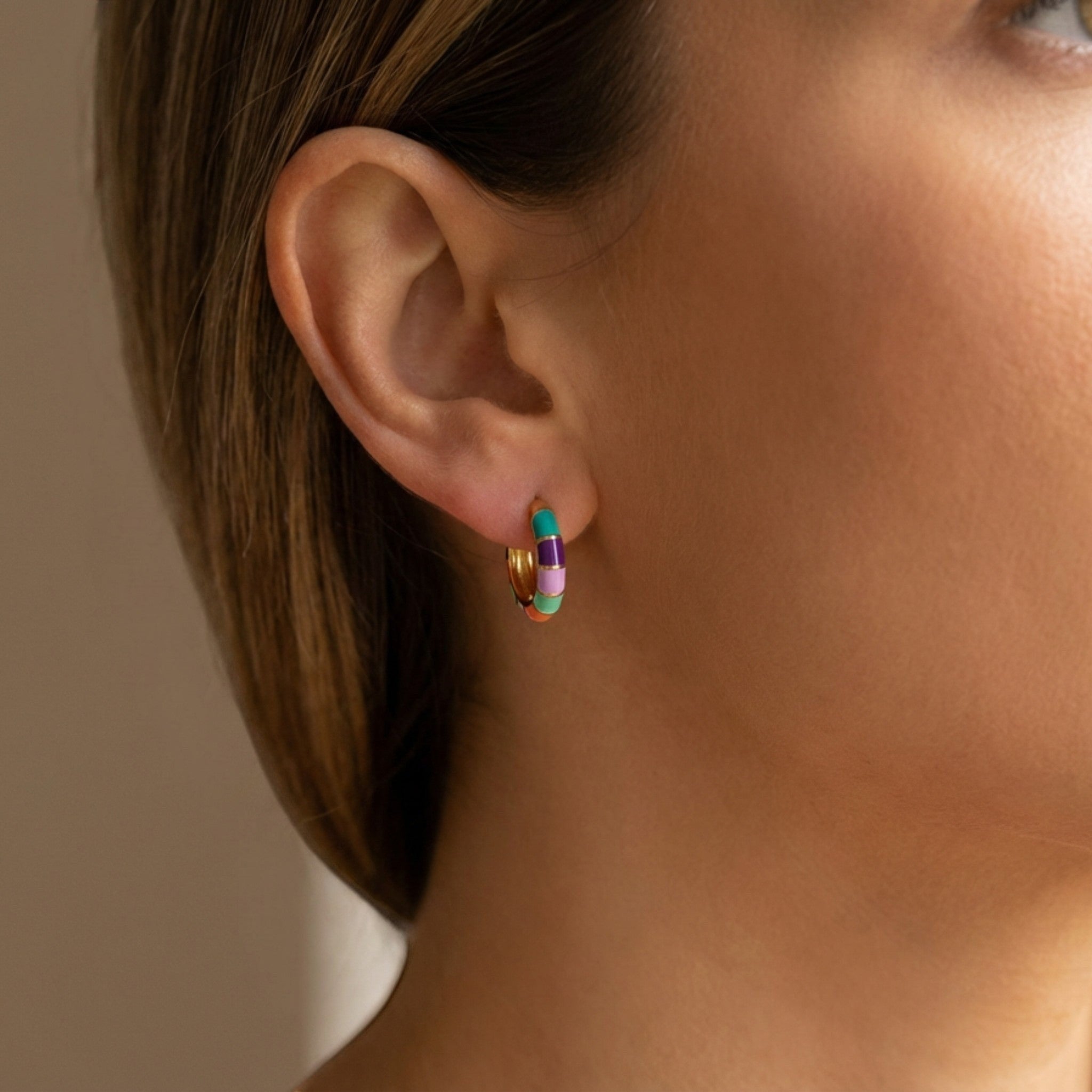 Tania Claire Australia gold-plated brass hoop earrings with colourful teal, violet, blush, and orange enamel segments.
