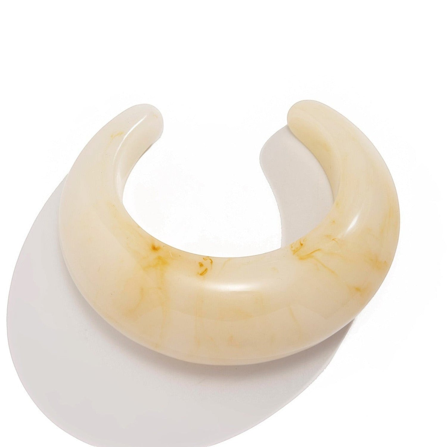 Tania Claire Australia cream marbled resin Billy Bangle bracelet with curved components and a swelling delicate look.
