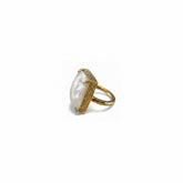 Tania Claire Australia Cleo Gemstone Ring with a large, iridescent white gemstone in a gold-tone prong setting.