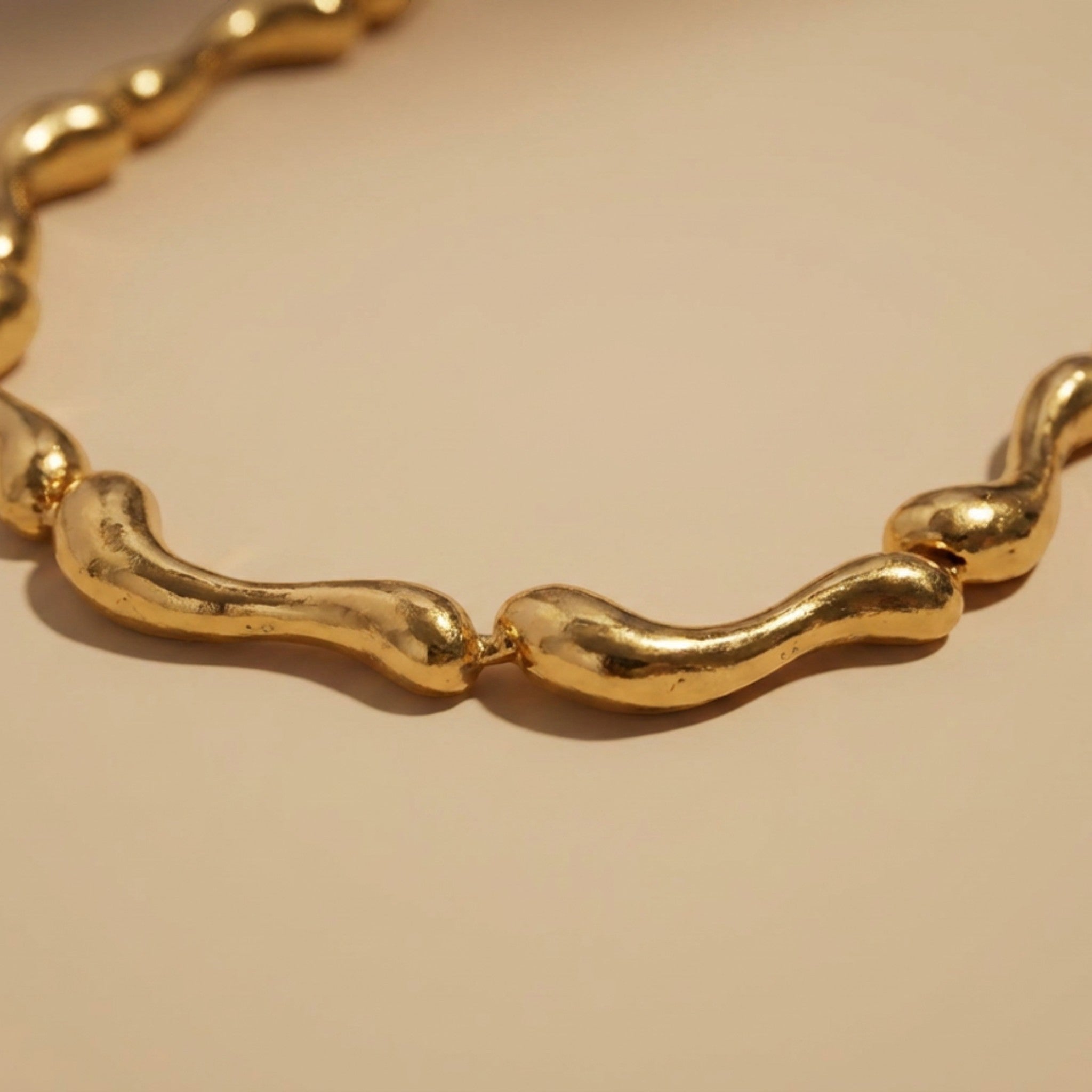 Tania Claire Australia Ocean Spine Necklace in 18K gold plating, featuring sculpted wave-like links for a fluid, coastal-inspired look.